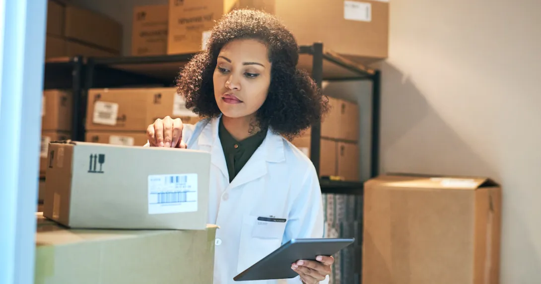 A pharmacist doing stock inventory using a digital tablet A pharmacist doing stock inventory using a digital tablet