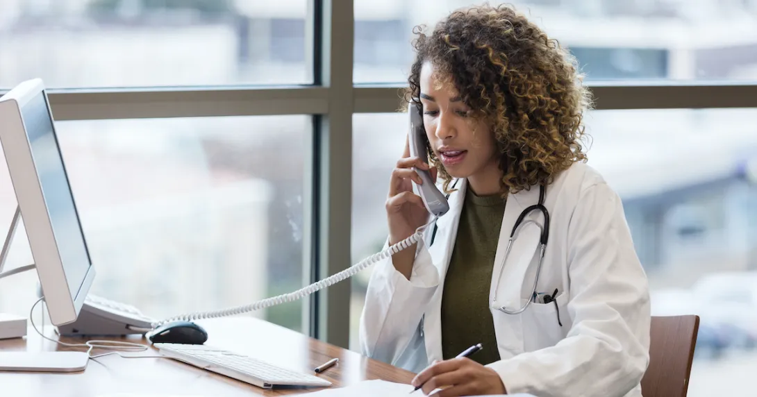 A doctor in a phone call consultation with a patient
A doctor in a phone call consultation with a patient