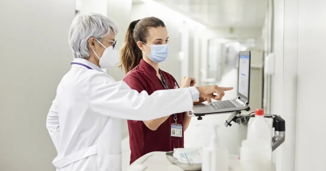 Healthcare professionals standing at a computer
Healthcare professionals standing at a computer