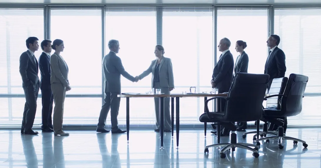 Business representatives shake hands to close a deal Business representatives shake hands to close a deal