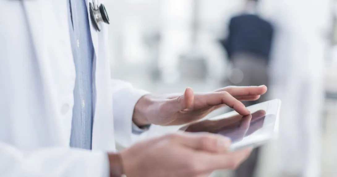 Healthcare provider's hands holding a tablet Healthcare provider's hands holding a tablet