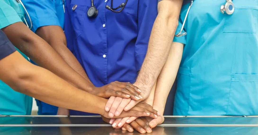 Healthcare providers putting their hands together Healthcare providers putting their hands together