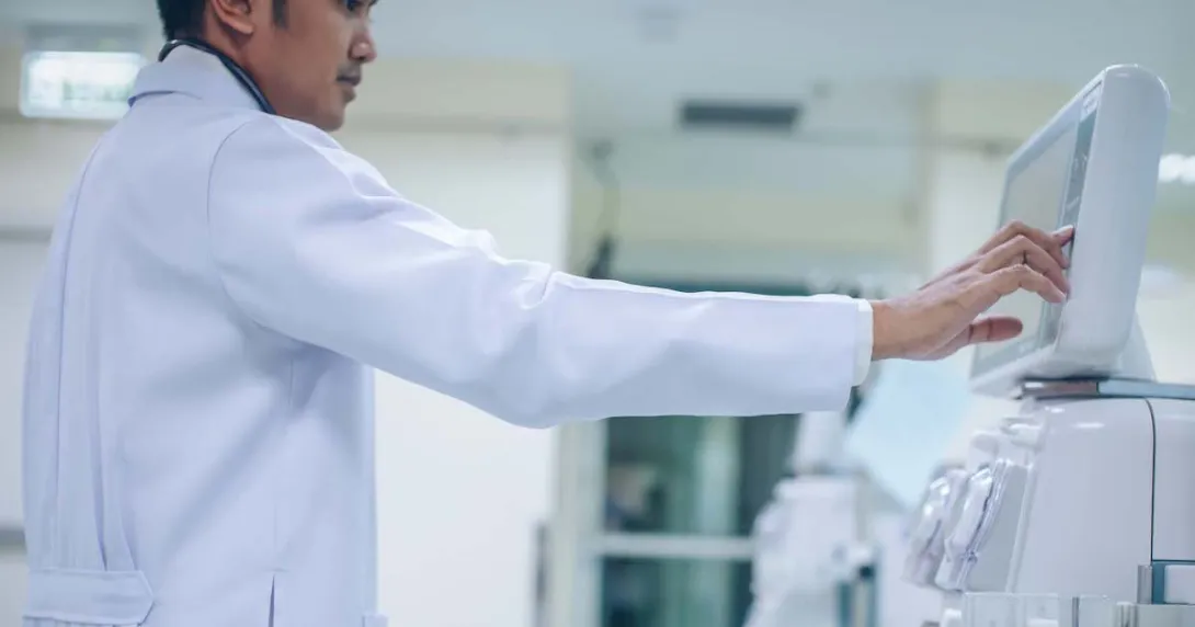 Doctor looking at a dialysis machine while in a care clinic or hospital
Doctor looking at a dialysis machine while in a care clinic or hospital