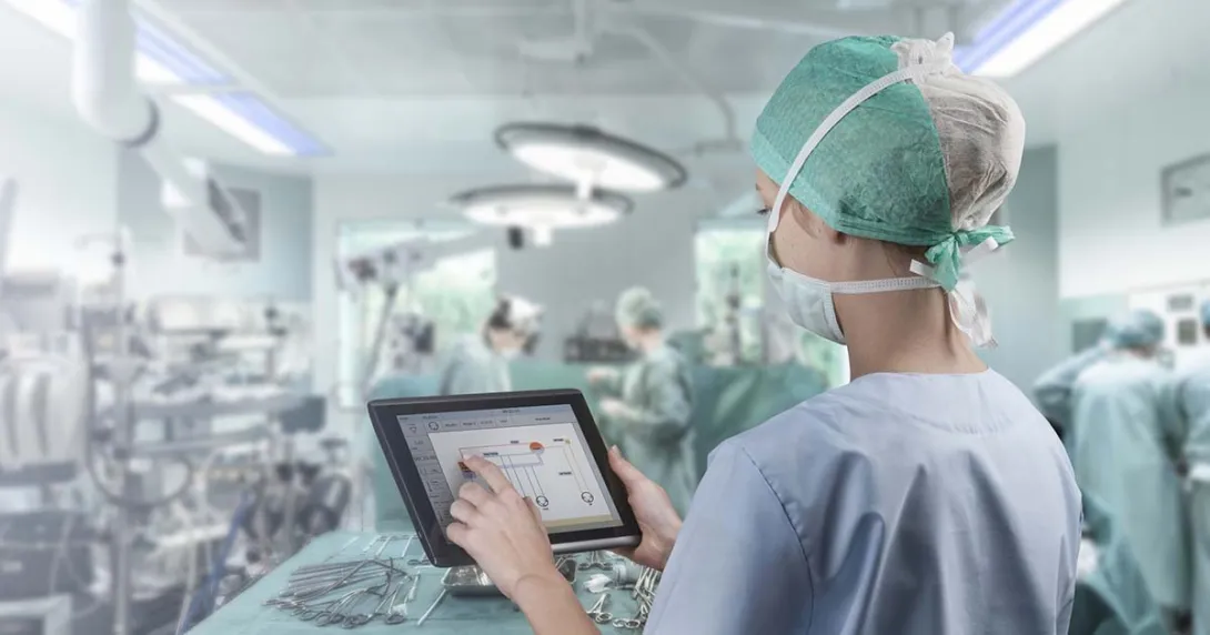 Surgeon in operating room looking at tablet
Surgeon in operating room looking at tablet