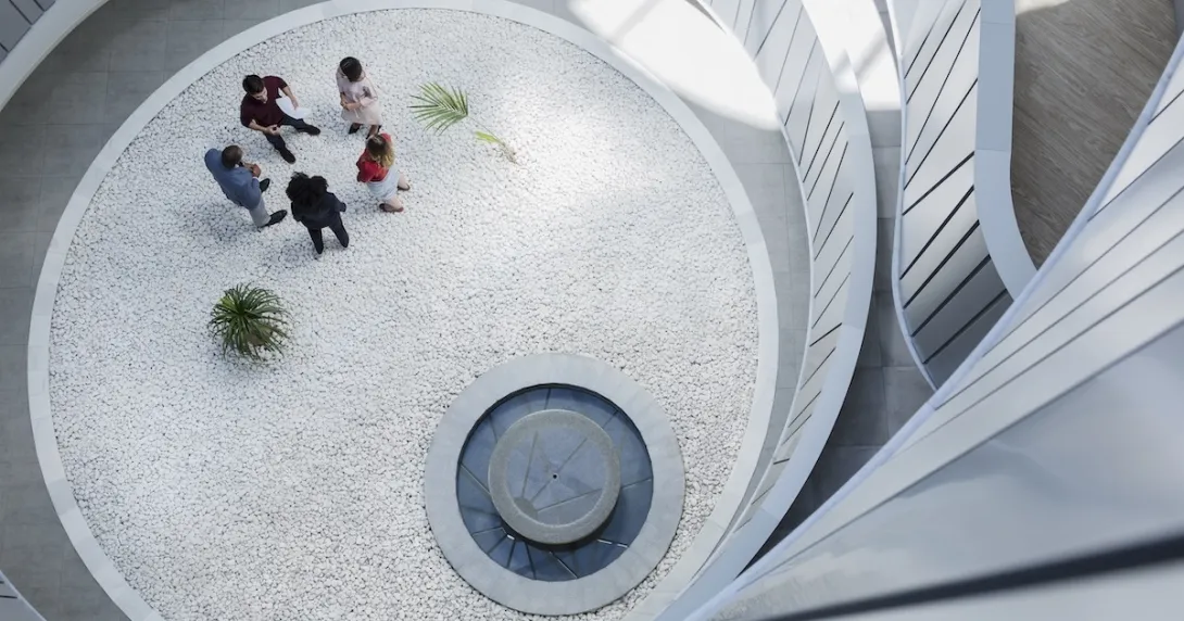 Employees gathering in an atrium Employees gathering in an atrium