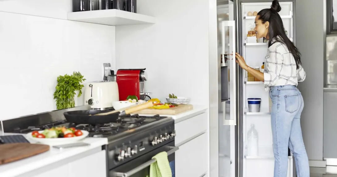 Person looking into a refrigerator Person looking into a refrigerator