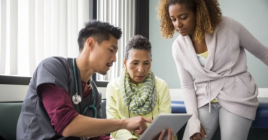 Healthcare provider consulting with a patient and family member Healthcare provider consulting with a patient and family member