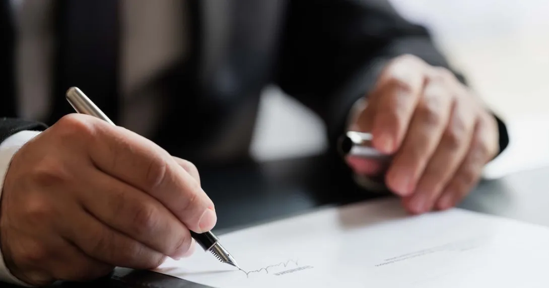 Person signing a document Person signing a document