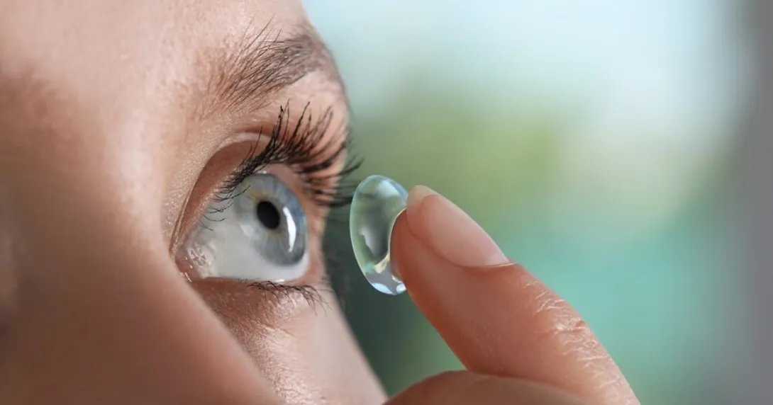 Person inserting a contact lens into their eye
Person inserting a contact lens into their eye