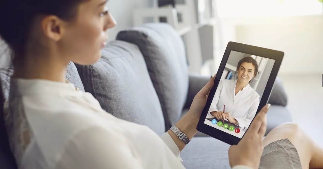 Person interacting with a healthcare professional via tablet Person interacting with a healthcare professional via tablet