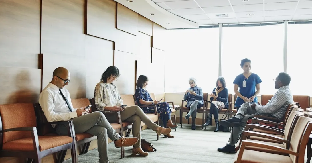 Patients sitting in a waiting room Patients sitting in a waiting room