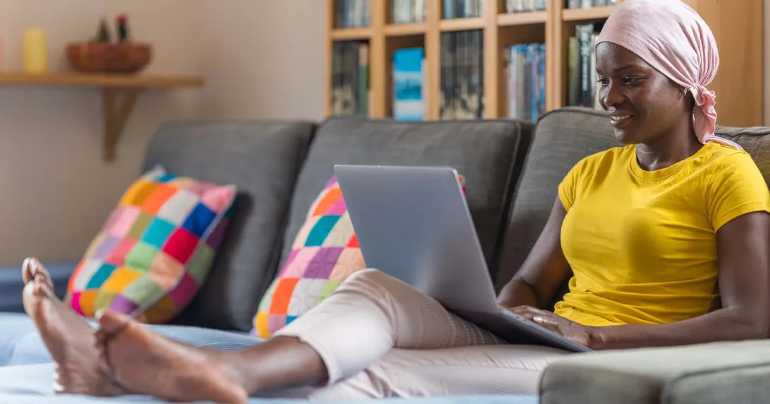 Person using laptop on a couch
Person using laptop on a couch