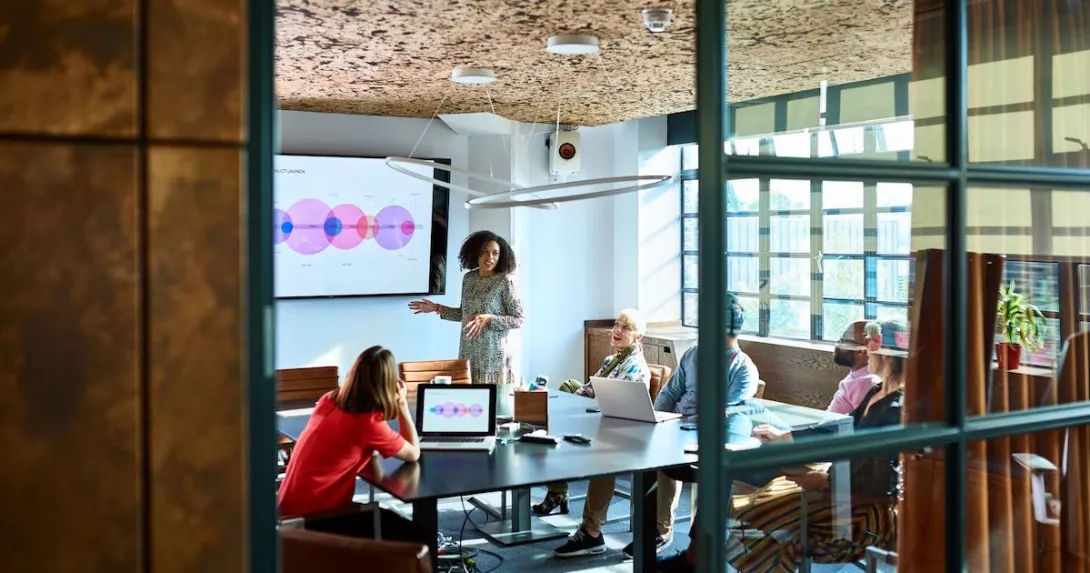 A person giving a presentation to colleagues.
A person giving a presentation to colleagues.
