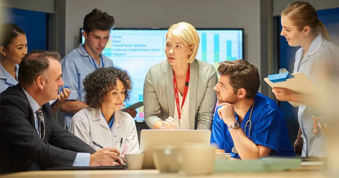 Businesspeople and doctors in a meeting together.
Businesspeople and doctors in a meeting together.
