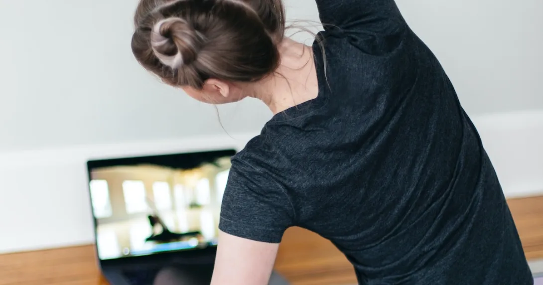 A person following a video stretch routine on their laptop
A person following a video stretch routine on their laptop