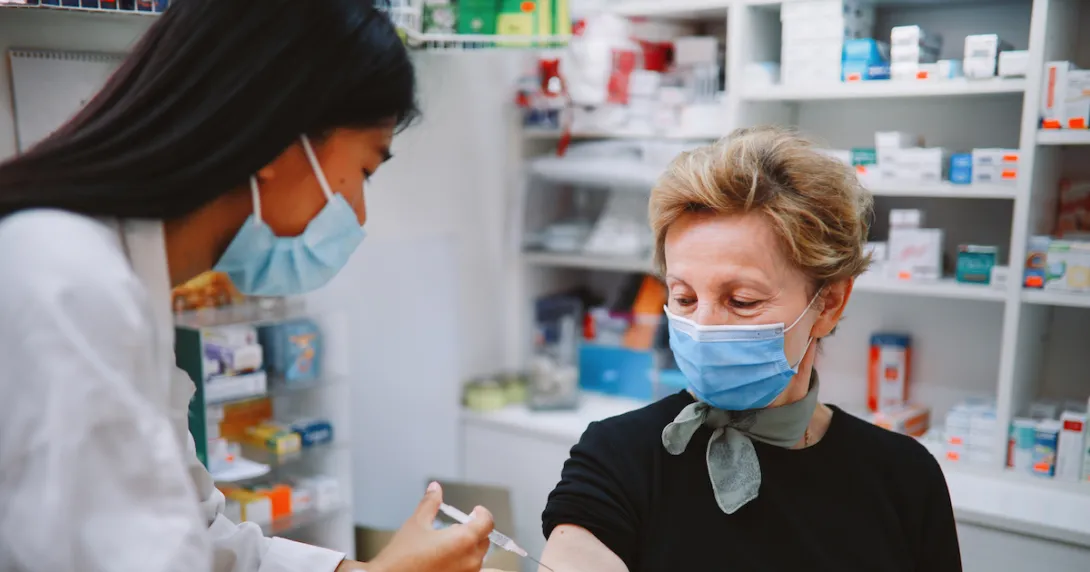 A person getting a vaccine at a pharmacy.
A person getting a vaccine at a pharmacy.
