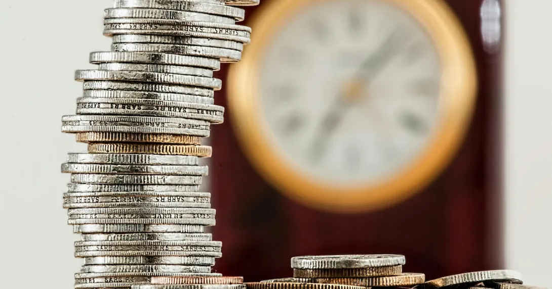 Coins and a clock on background Coins and a clock on background
