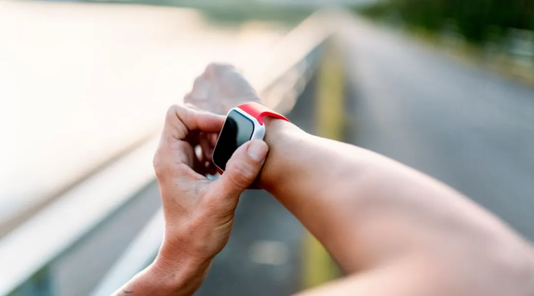 A close-up of a person wearing a smartwatch.
A close-up of a person wearing a smartwatch.