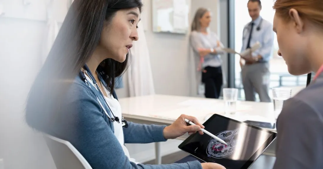 Two people looking at a tablet with an ultrasound image of a brain on the screen
Two people looking at a tablet with an ultrasound image of a brain on the screen