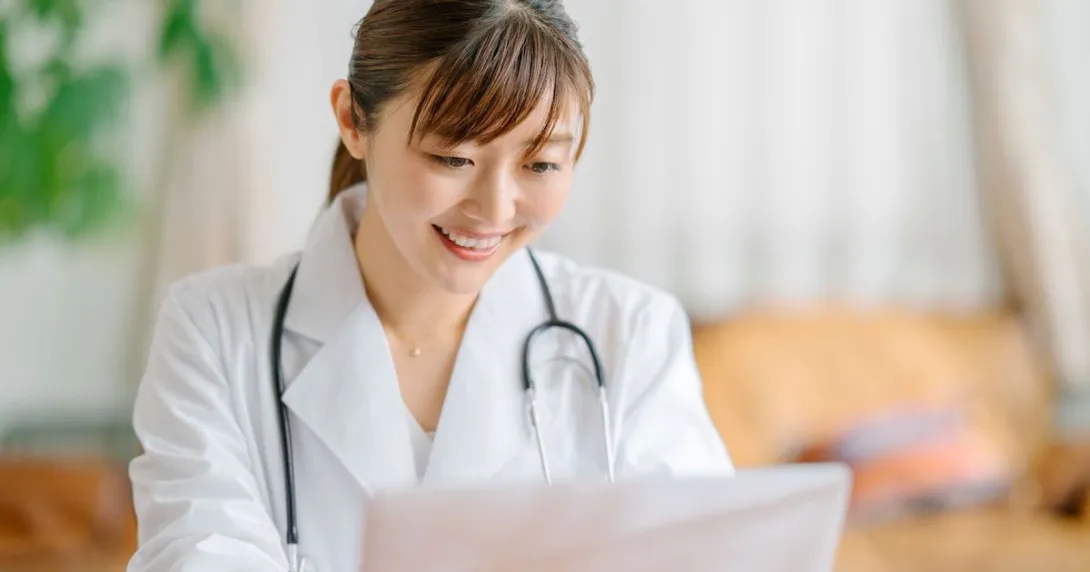 Healthcare provider sitting at a desk looking at a computer
Healthcare provider sitting at a desk looking at a computer