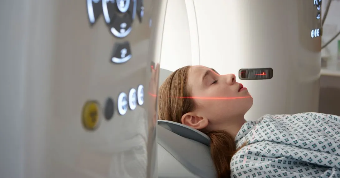 Person being drawn into a diagnostic imaging machine while wearing a hospital gown Person being drawn into a diagnostic imaging machine while wearing a hospital gown