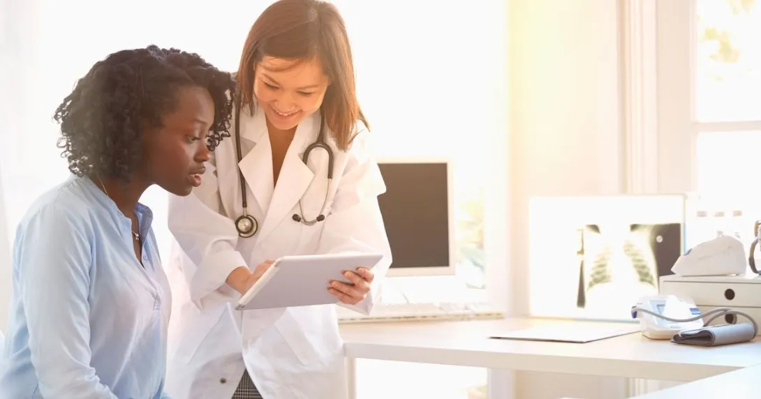 Healthcare provider in the clinical setting with a patient Healthcare provider in the clinical setting with a patient