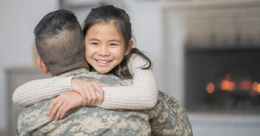 Soldier in uniform with his back turned while hugging someone not in uniform Soldier in uniform with his back turned while hugging someone not in uniform