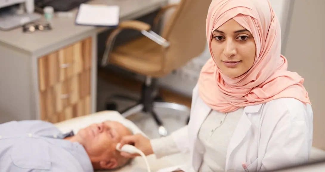 Healthcare professional performing an ultrasound on a patient Healthcare professional performing an ultrasound on a patient