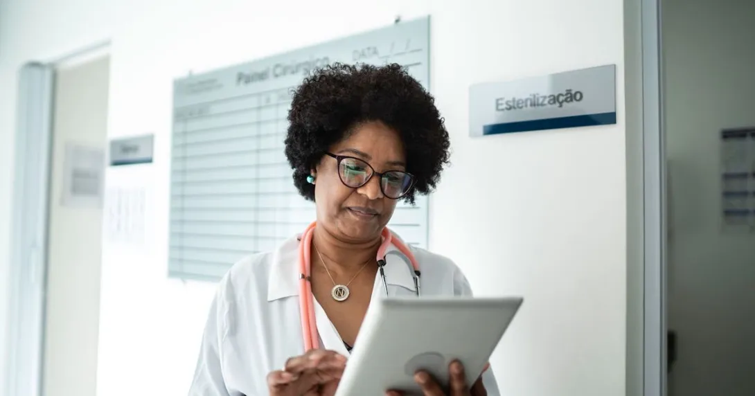 Healthcare provider on a tablet walking through a clinic
Healthcare provider on a tablet walking through a clinic