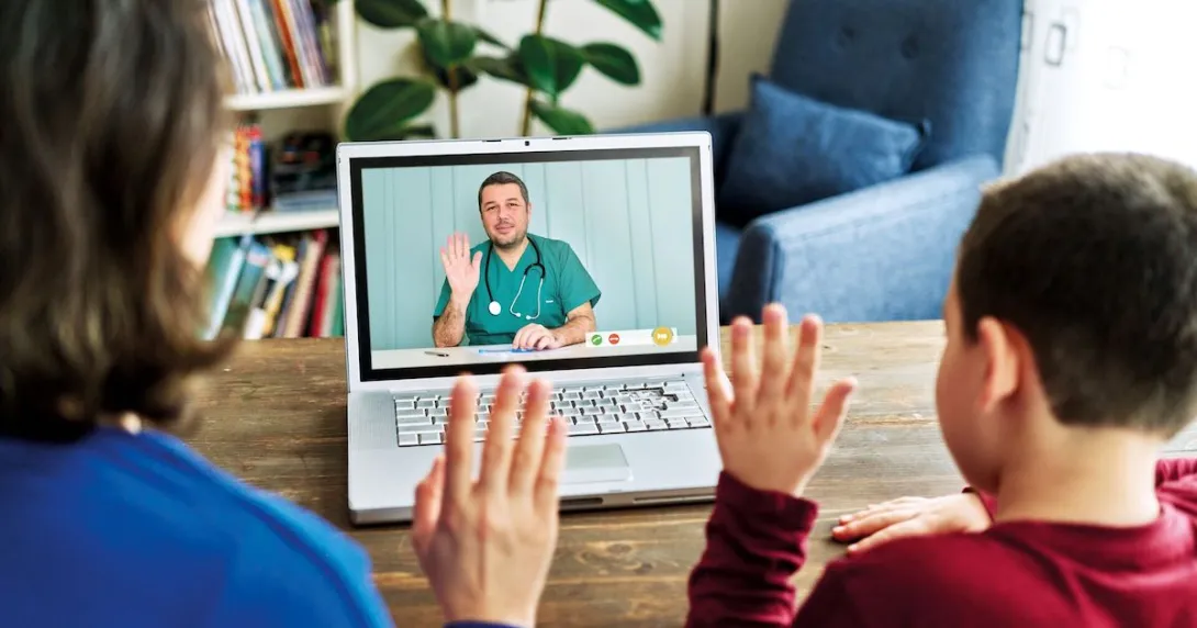 Two people waving at a healthcare provider on a computer
Two people waving at a healthcare provider on a computer