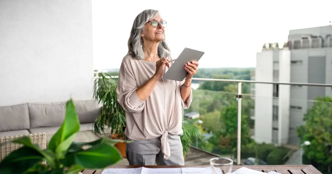 Person standing on a balcony looking at the sky with a tablet in their hand
Person standing on a balcony looking at the sky with a tablet in their hand