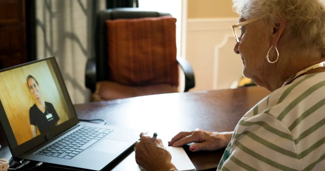 Person talking with nurse on laptop Person talking with nurse on laptop