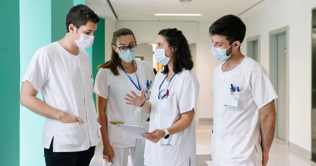 Healthcare workers standing in a hallway talking
Healthcare workers standing in a hallway talking