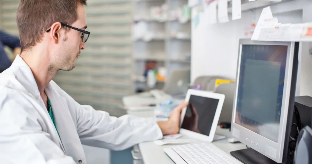 Healthcare provider looking at two computers
Healthcare provider looking at two computers