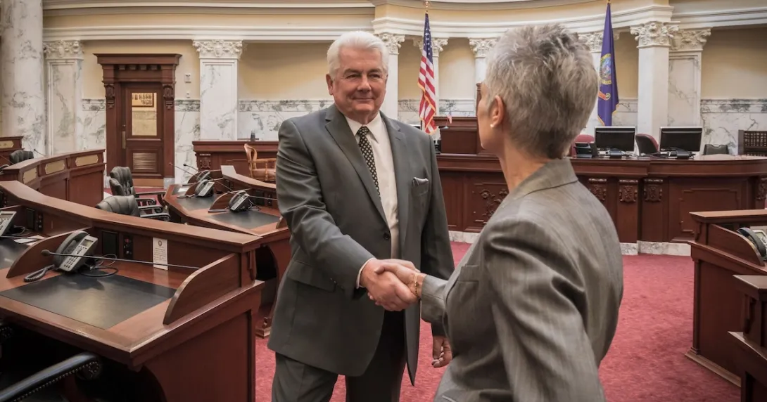 Two people shaking hands in a government building Two people shaking hands in a government building
