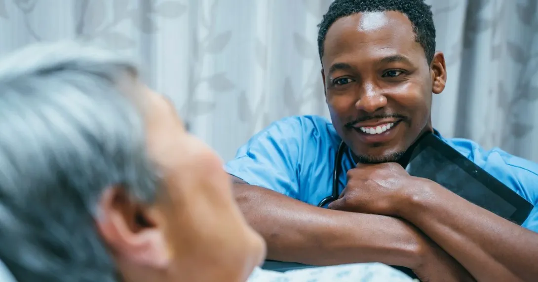 Healthcare provider speaking to a patient while smiling
Healthcare provider speaking to a patient while smiling