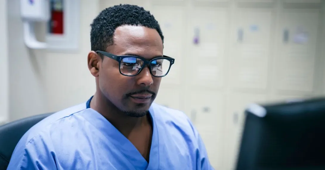 Healthcare provider wearing glasses, sitting in front of a computer monitor
Healthcare provider wearing glasses, sitting in front of a computer monitor