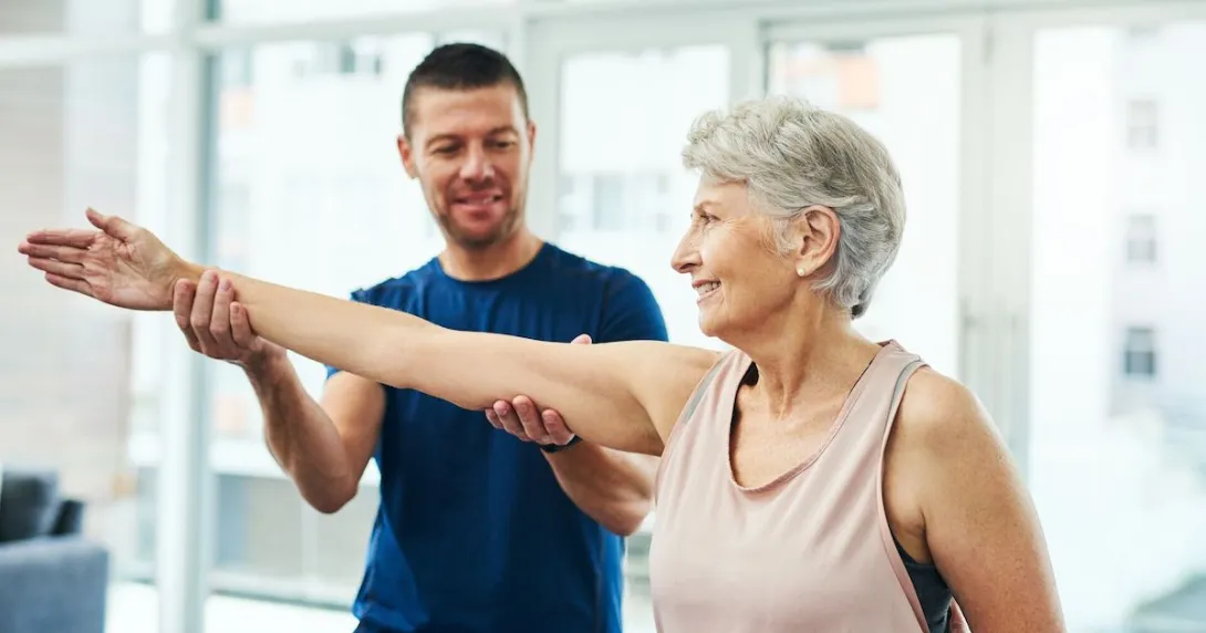 A physiotherapist working with a senior patient A physiotherapist working with a senior patient