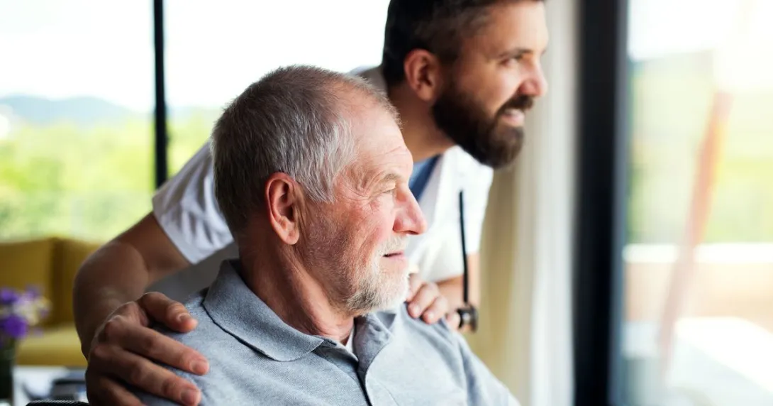 A senior patient and a caregiver looking out the window
A senior patient and a caregiver looking out the window