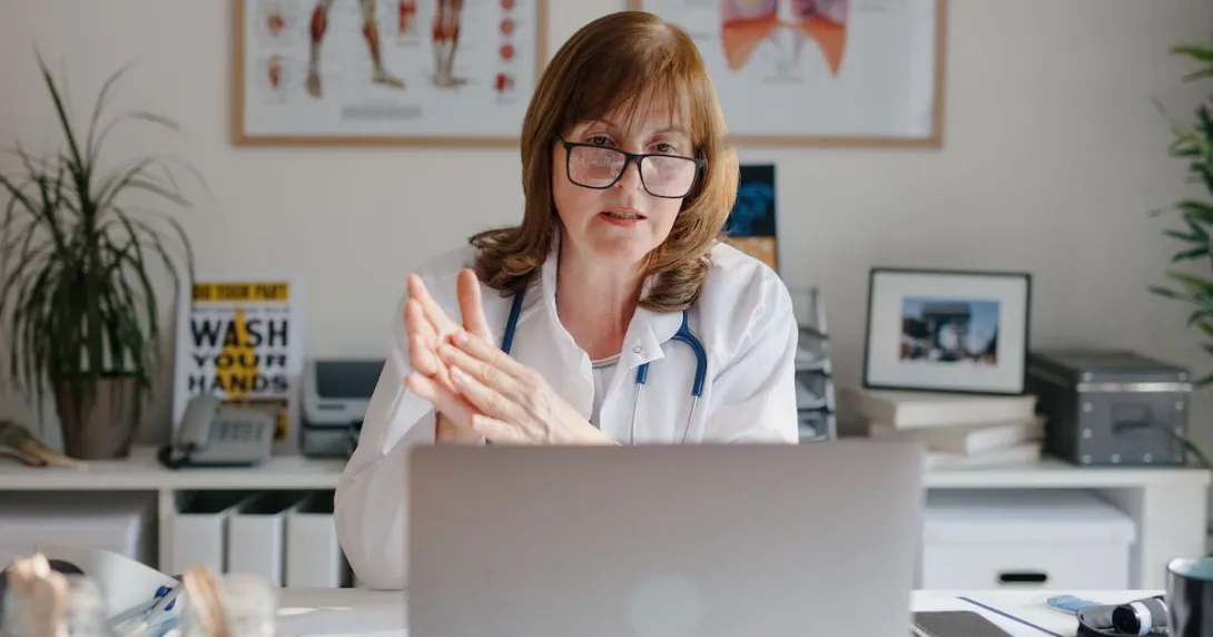 A doctor using a laptop for a virtual consultation A doctor using a laptop for a virtual consultation