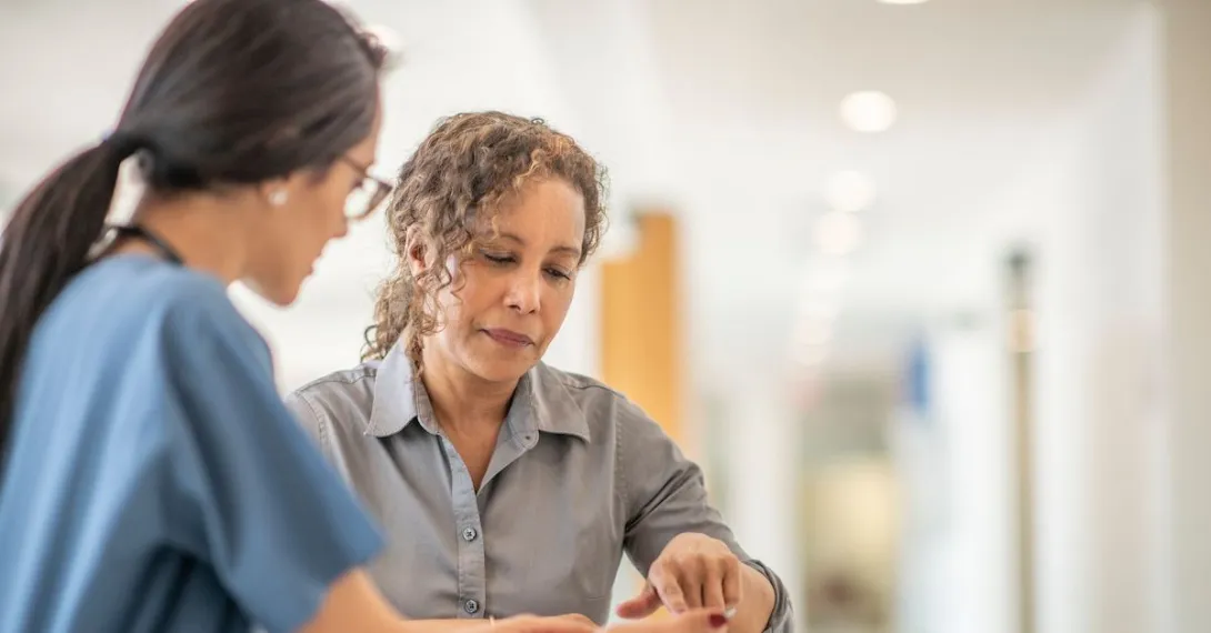 A person talking to her doctor.
A person talking to her doctor.