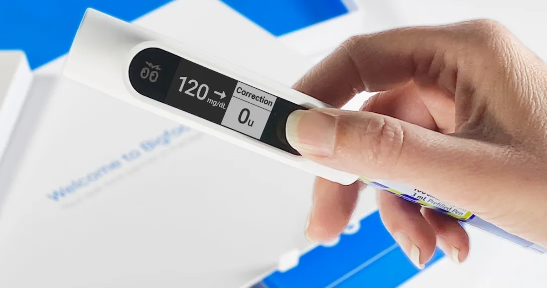 Hand holding Bigfoot rapid-acting smart insulin pen