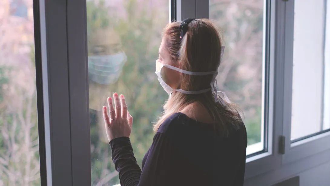 Person looking outside longingly