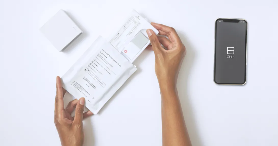 User opening up the Cue Health Monitoring System
