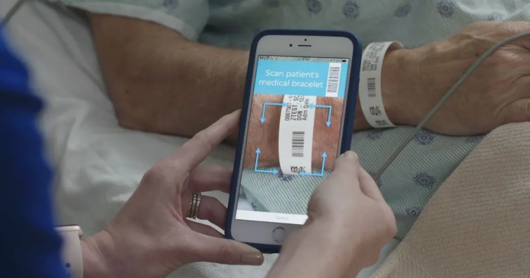 nurse scanning hospital patient bracelet with smartphone