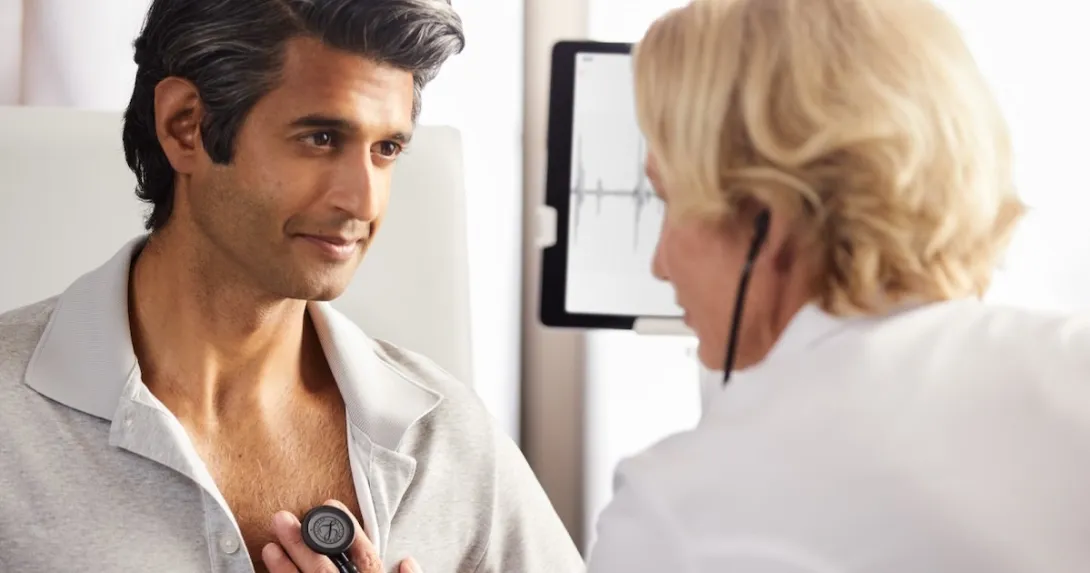 A healthcare professional using an Eko stethoscope with a patient A healthcare professional using an Eko stethoscope with a patient