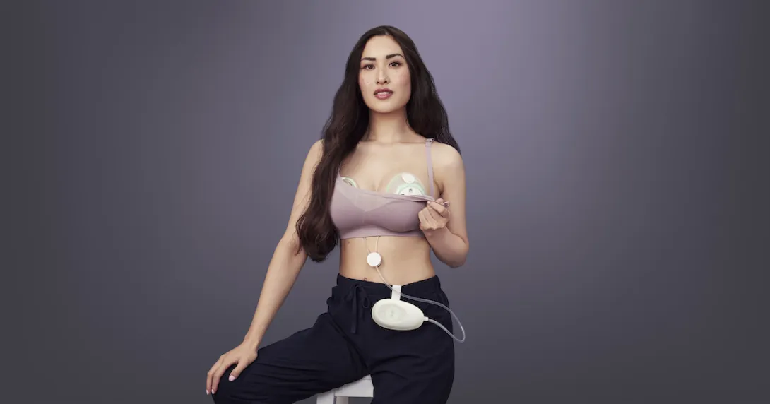 New parent wearing Elvie Stride in their bra posed on a black background