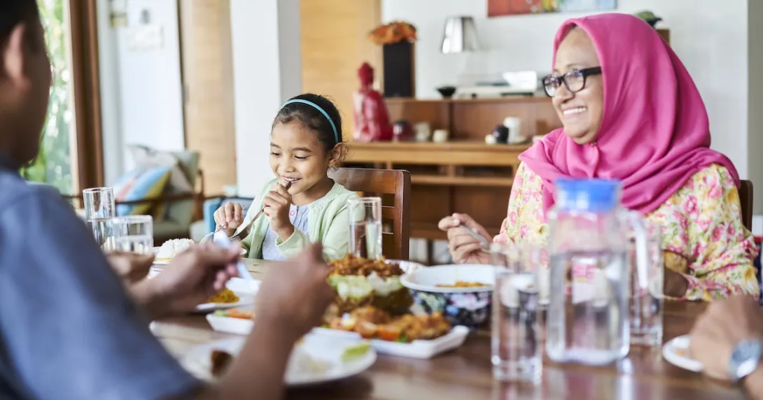 multigenerational family eating a meal at a table