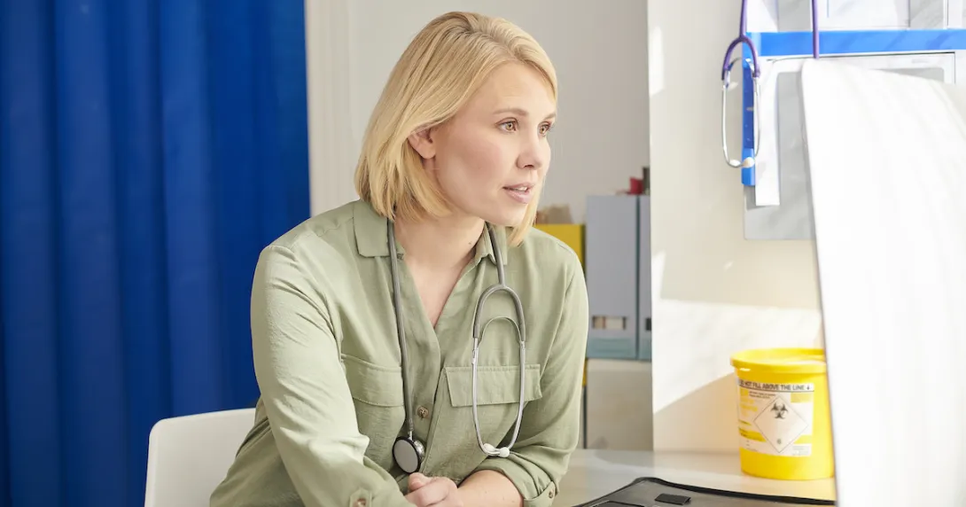 Healthcare provider sitting in a room Healthcare provider sitting in a room