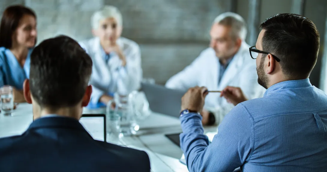Business persons sitting around a table Business persons sitting around a table